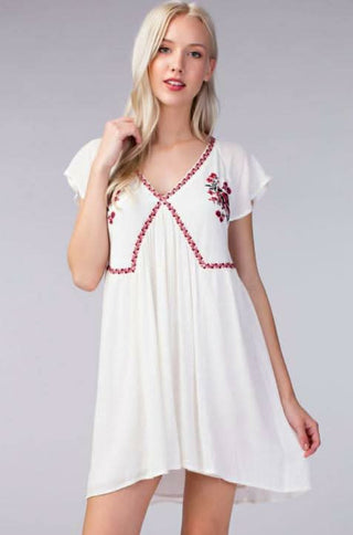 White embroidered babydoll beach dress styled for a summer outfit