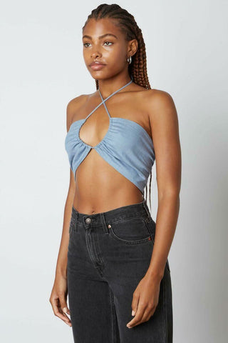 Side profile of a slate blue bandeau-style halter top with adjustable neck ties