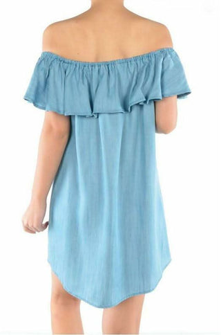 Rear view of the light blue Tencel denim dress showing the ruffled elastic neckline and rounded hem.