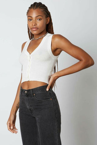 White sleeveless knit crop top showing the functional button-down front