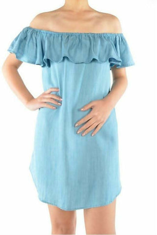 Model wearing the See Ya In Miami Light Blue Chambray Off-the-Shoulder Dress featuring a ruffle neckline and shift silhouette.
