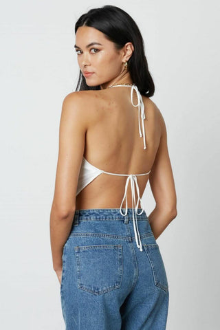 White satin halter top with open tie-back and handkerchief silhouette