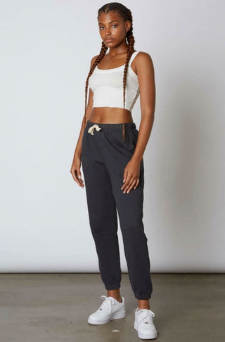 Side profile view of relaxed-fit grey fleece sweatpants with elasticized cuffs 