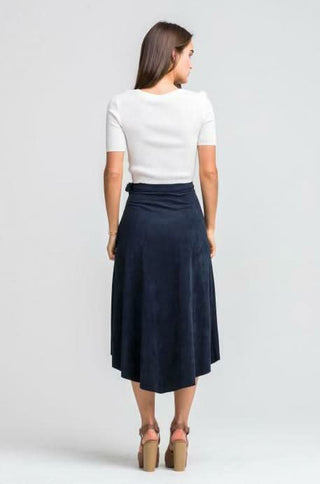 Back view of navy blue faux suede midi wrap skirt showing the high-waisted fit and midi length.
