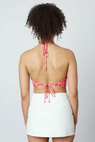 Satin red floral crop top with crisscross halter neckline - back view