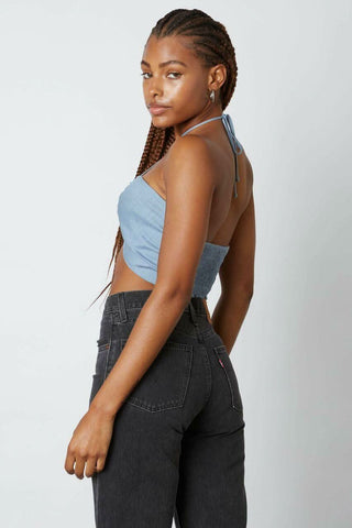 Back view of a slate blue halter crop top showing the tie-neck closure 