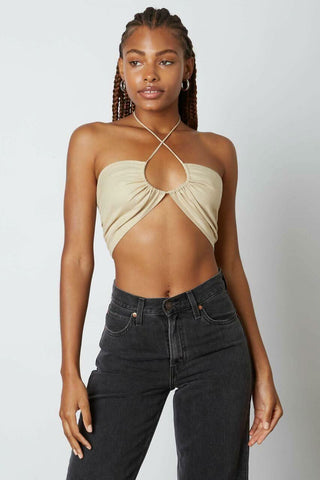 Woman wearing a jute bandeau cross-front halter crop top with front keyhole 