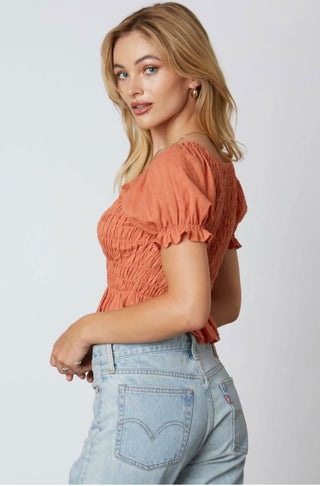 Dana Terra Cotta Smocked Puff Sleeve Ruffle Top side view