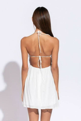 Back view of Monika White Cutout Halter Mini Dress showing open back 