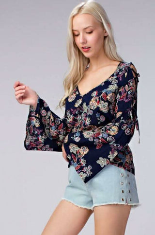 navy floral cold shoulder bell sleeve top styled with raw hem shorts