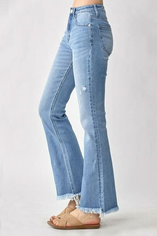 Side view of a model wearing high waisted vintage flare jeans styled with sandals