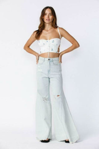 Fiona White and Blue Floral Backless Bustier Crop Top styled with high-waisted flare  jeans