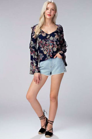 navy floral bell sleeve blouse outfit with denim shorts