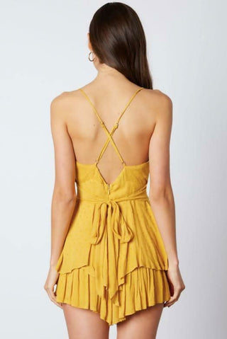 Mustard yellow open back romper with crisscross straps