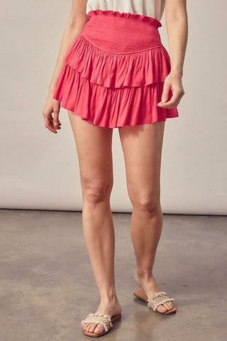 Hot pink mini skort with smocked waistband and flowy ruffle tiers
