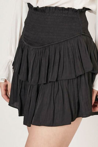 Black mini skort with smocked waistband and flowy ruffle tiers