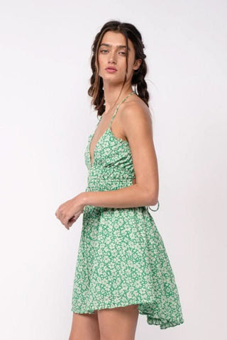 Green floral vacation dress with halter neckline and ruffle details