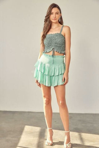 Green ruffle mini skort with smocked waistband and flowy tiers