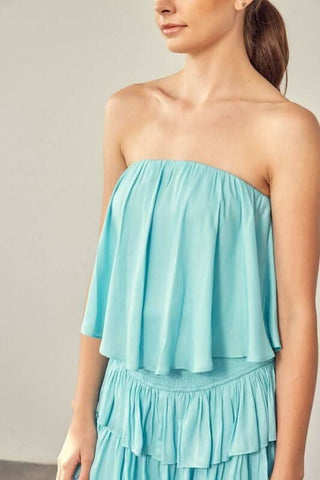 Milky blue ruffle romper detail showing layered skirt overlay